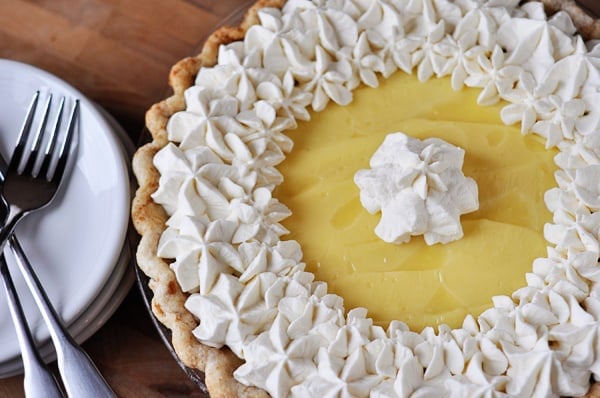 top view of a banana cream pie with piped whipped cream around the edges and middle