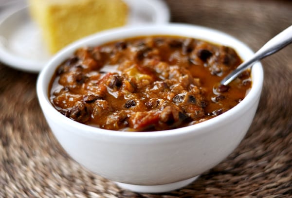 White bowl full of black bean pumpkin chili.