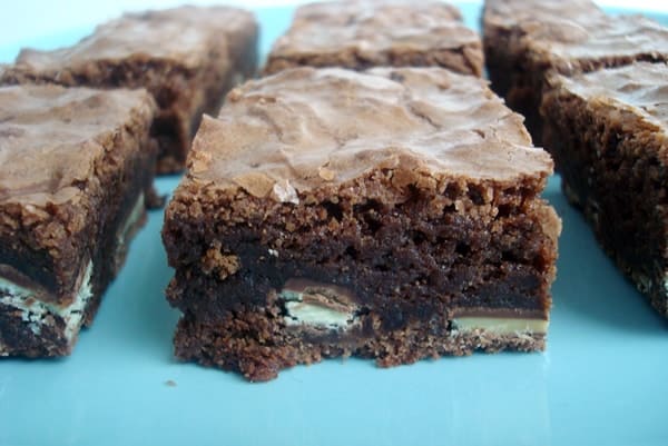 Cut up Andes Mint brownies on a blue plate.