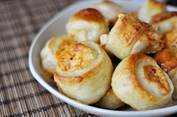 White bowl with golden-brown cooked buffalo chicken bites.