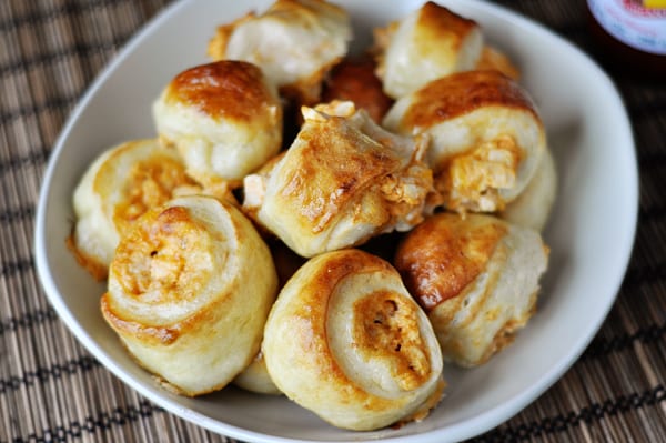 Top view of a white bowl with cooked buffalo chicken bites.