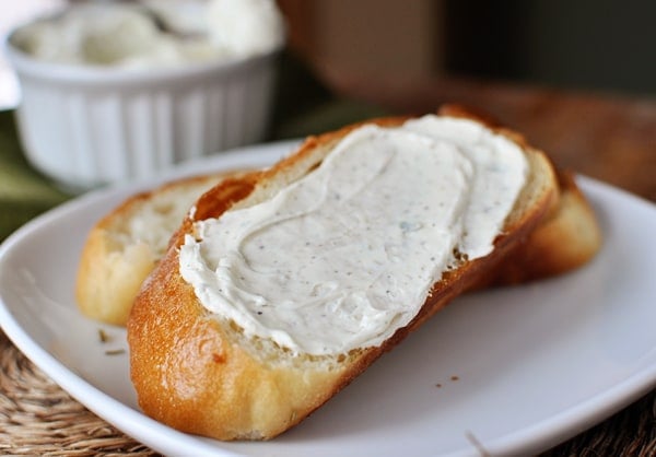 Slice of bread covered with garlic herb butter mixture.