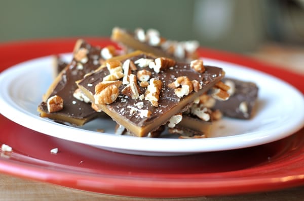 Red plate full of toffee-topped toffee crunch.