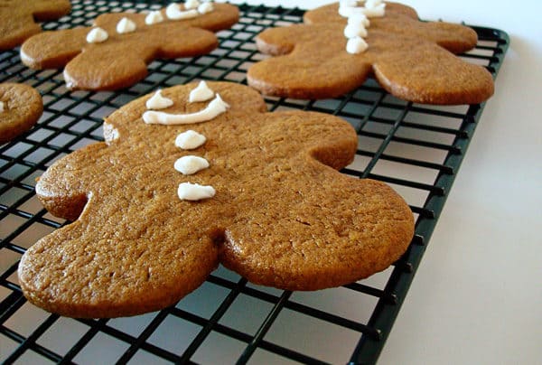 a gingerbread man with icing buttons and face on a cooling rack