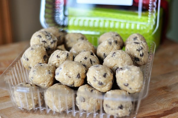 a plastic container filled with frozen cookie dough balls