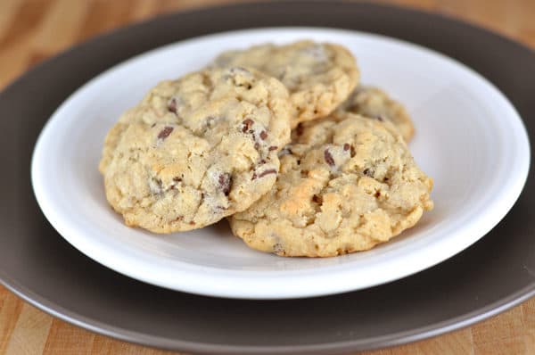 White plate with three chocolate chip cookies.