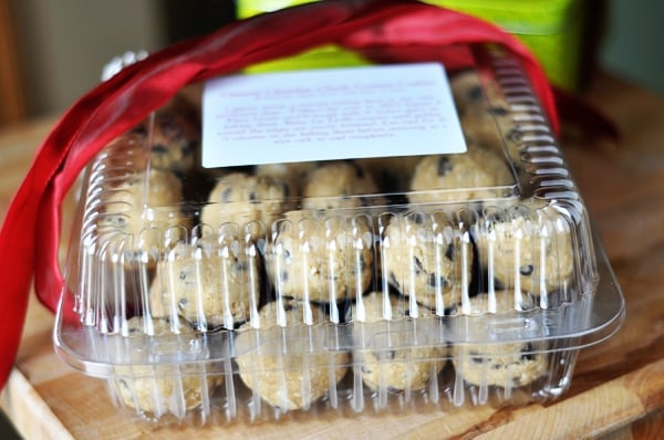 front view of a plastic container filled with chocolate chip cookie dough balls