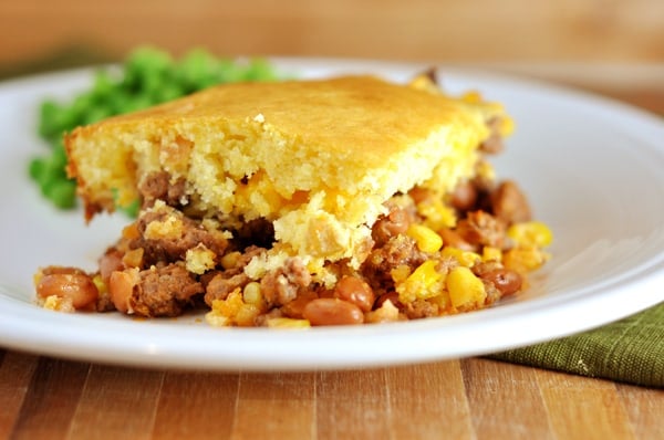 Bean and corn cornbread-topped dinner on a white plate.