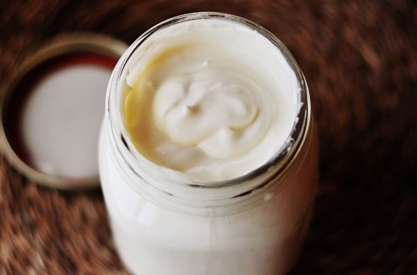 Glass mason jar full of homemade creme fraiche.