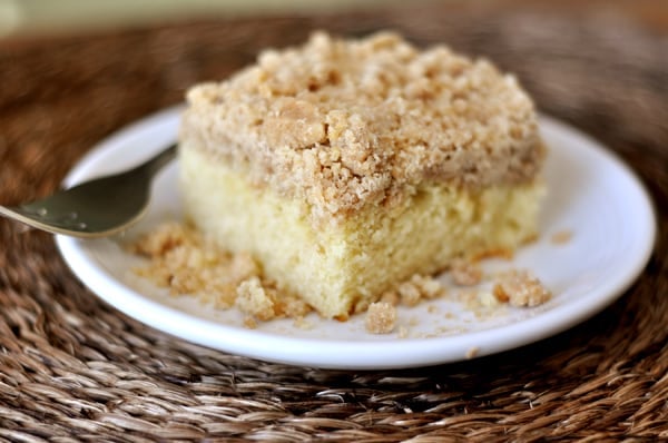 A piece of new york style crumb cake on a white plate.