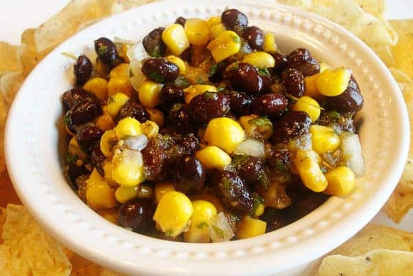 White bowl with corn and black bean salsa.