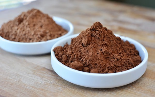 two white bowls full of different kinds of baking cocoa