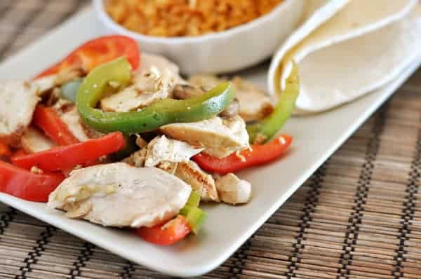 white platter with fajita chicken strips, and pepper strips