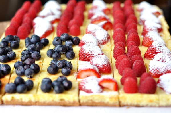 Cheesecake squares decorated with berries to look like an American flag.