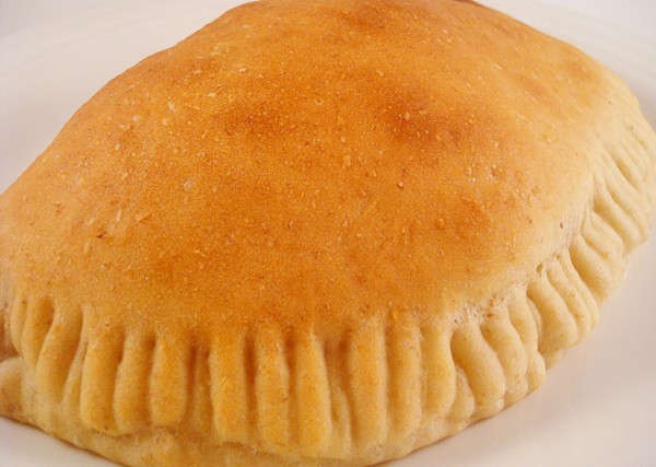 baked calzone on a white plate