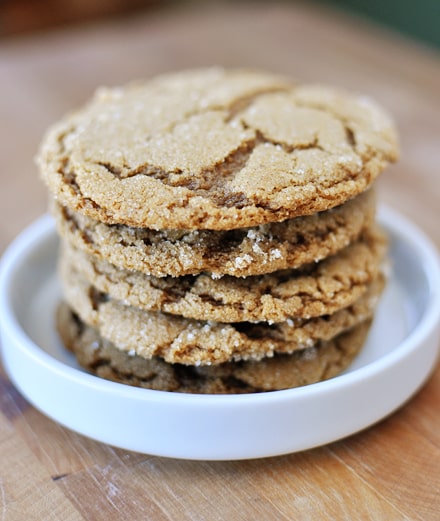 A stack of ginger crinkle cookies in a small white ramekin.