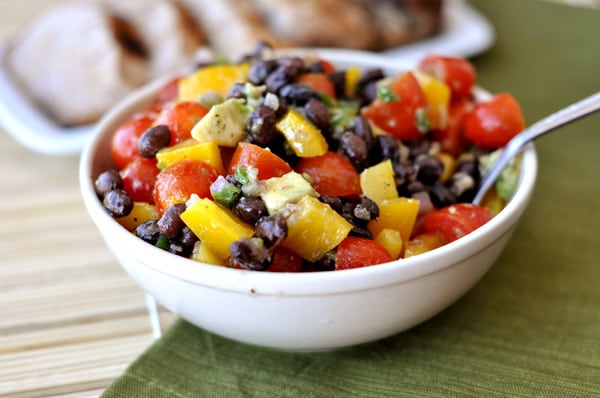a white bowl with a black bean and veggie salad