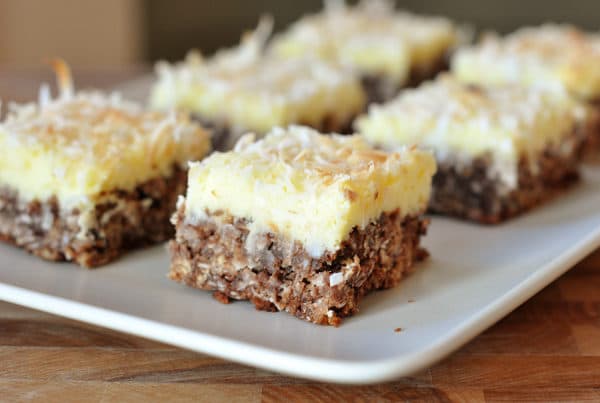 White platter with squares of cream cheese chocolate bars.