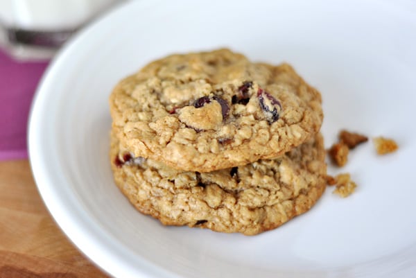 A white plate with two stacked oatmeal cookies.