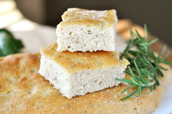 Squares of focaccia bread on top of a flat disk of focaccia.
