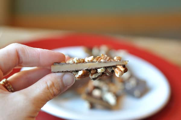 Side view of a piece of pecan buttercrunch.