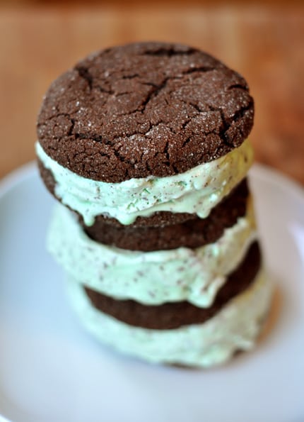 Stack of chocolate mint chip ice cream sandwiches on a white plate.