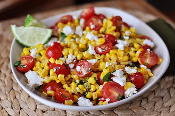 White bowl with top view of mexican tomato and corn salad.