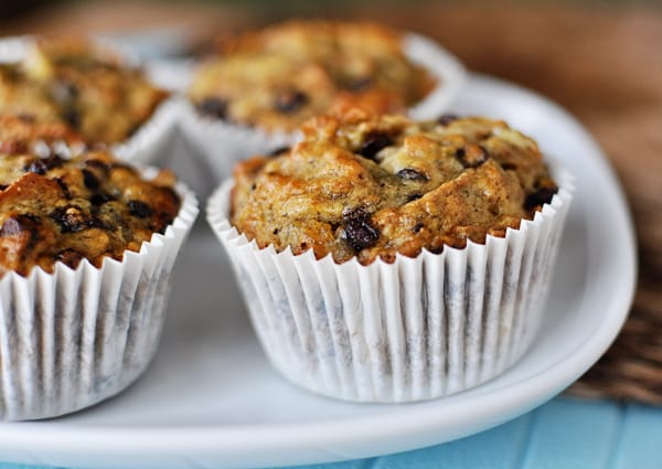 White plate with banana bran muffins in white liners.