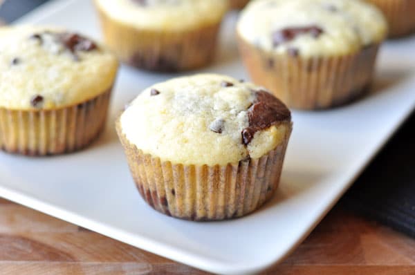 Chocolate and orange swirled muffins on a white platter.