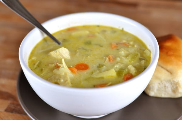 White bowl full of chicken and vegetable mulligatawny soup.