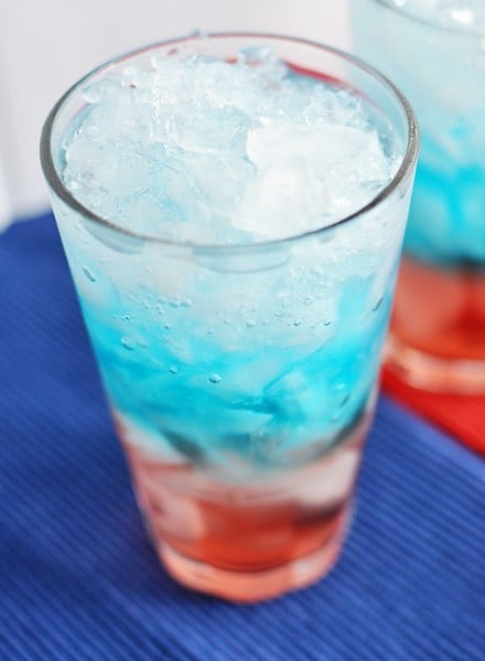 Top view of a red, white, and blue layered drink in a glass cup.