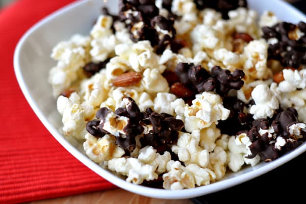 A white bowl full of chocolate-dipped kettle corn.