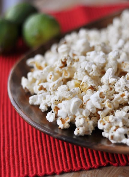 Spice-topped popped popcorn on a brown plate.