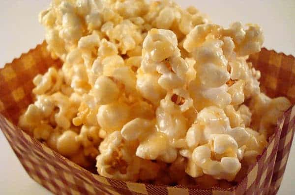 Caramel popcorn in a brown basket.