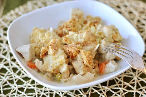 White plate with chicken pot pie filling and a crumble top.