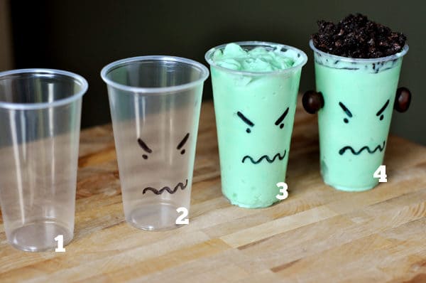 Four plastic cups showing the different steps to assembling monster pudding cups.