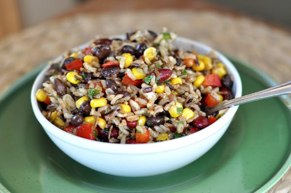 White bowl with rice, bean, corn, and pepper salad.