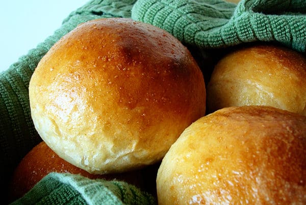golden brown rolls on top of a green towel