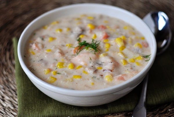 White bowl with smoked salmon corn chowder.