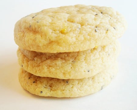 Stack of lemon poppy seed cookies on a white plate.