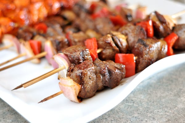 A platter of grilled beef and vegetable kebabs. 