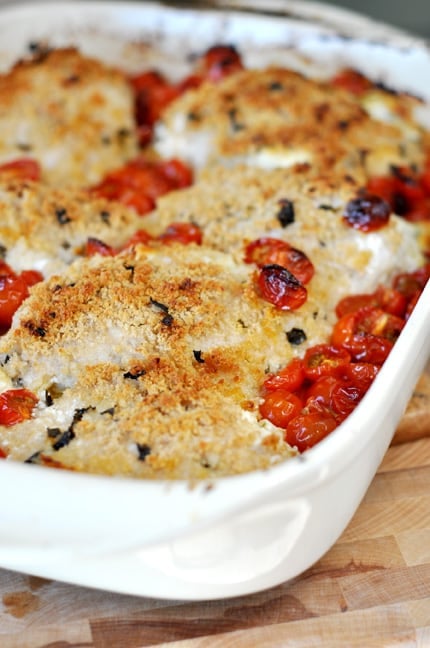 White casserole dish with cheese and panko crusted chicken breasts.