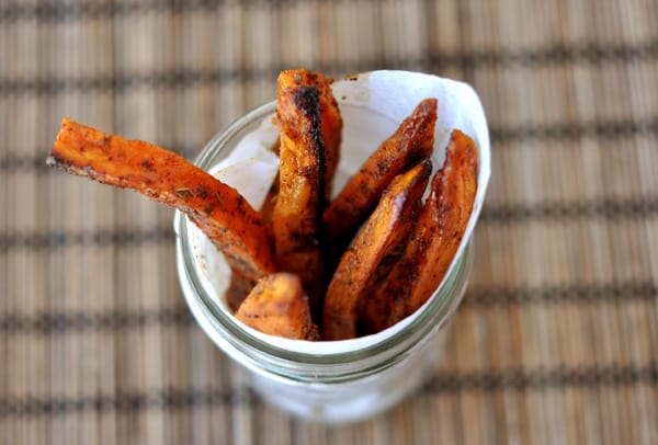 A top view of a jar with cooked sweet potato fries standing up in the jar.