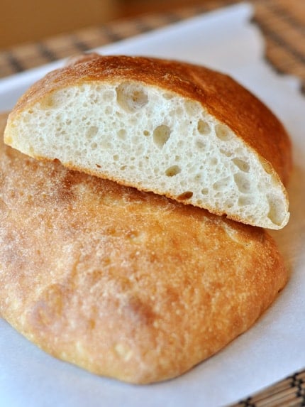 A loaf of ciabatta bread sliced in half.