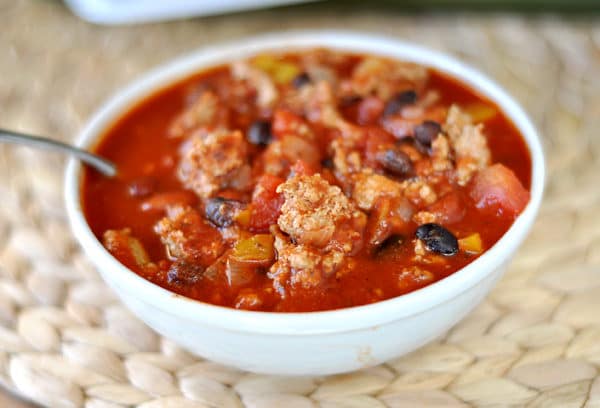 Top view of a white bowl with black bean turkey chili.