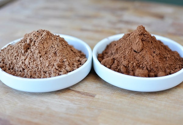 two small white bowls of baking cocoa next to each other 