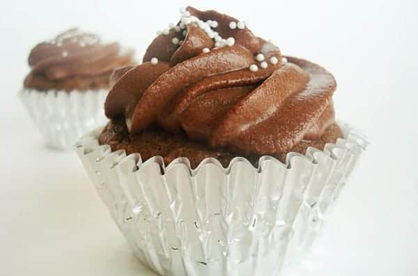 Chocolate frosted cupcake in a silver muffin liner.