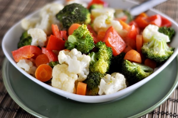 Sautéed peppers, carrots, broccoli, and cauliflower in a white dish.