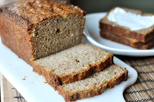 A loaf of zucchini bread with two slices cut off. 