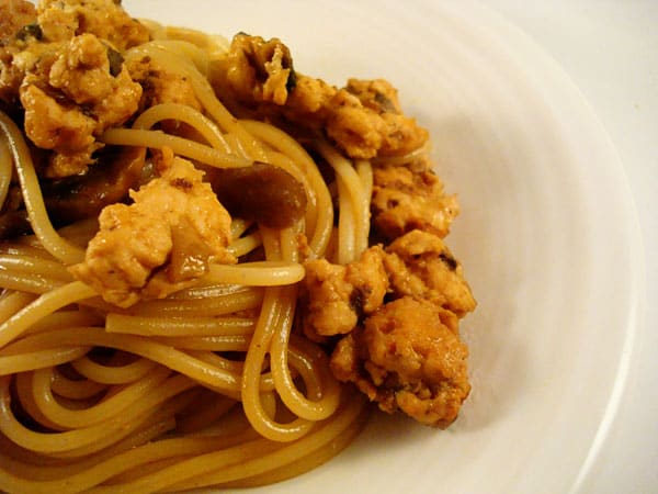 Big helping of asian noodles on a white plate.